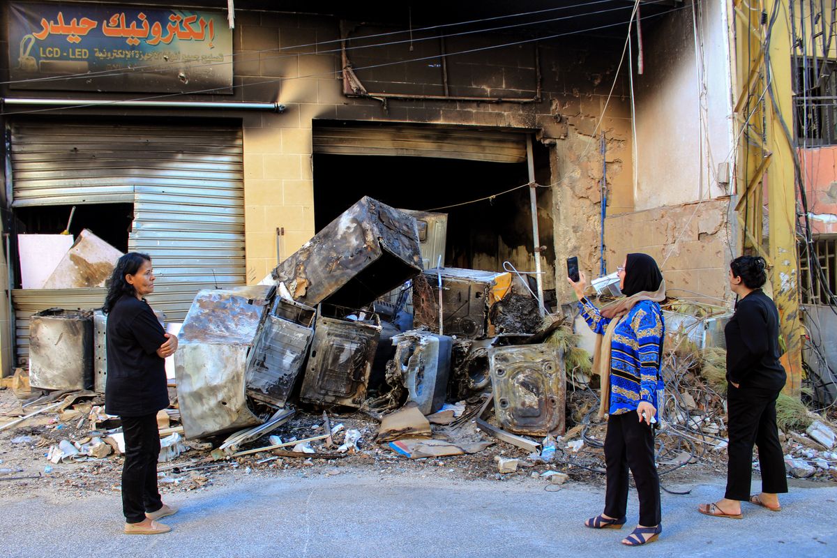 Lebanese women inspect destruction caused by Israeli strikes in southern Lebanese border village of Khiam during a fighting between pro-Iranian Hezbollah and Israeli forces.