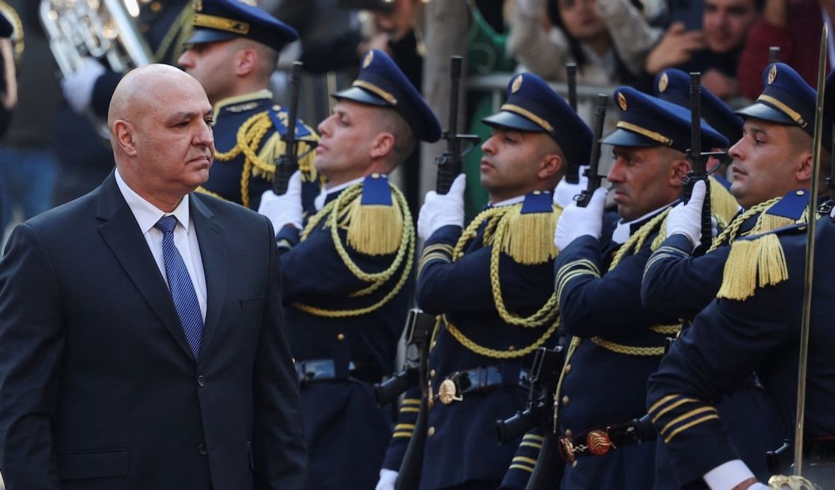 ​Lebanon's army chief Joseph Aoun walks past guards at the parliament building in Beirut, Lebanon, on Jan. 9, 2025. 