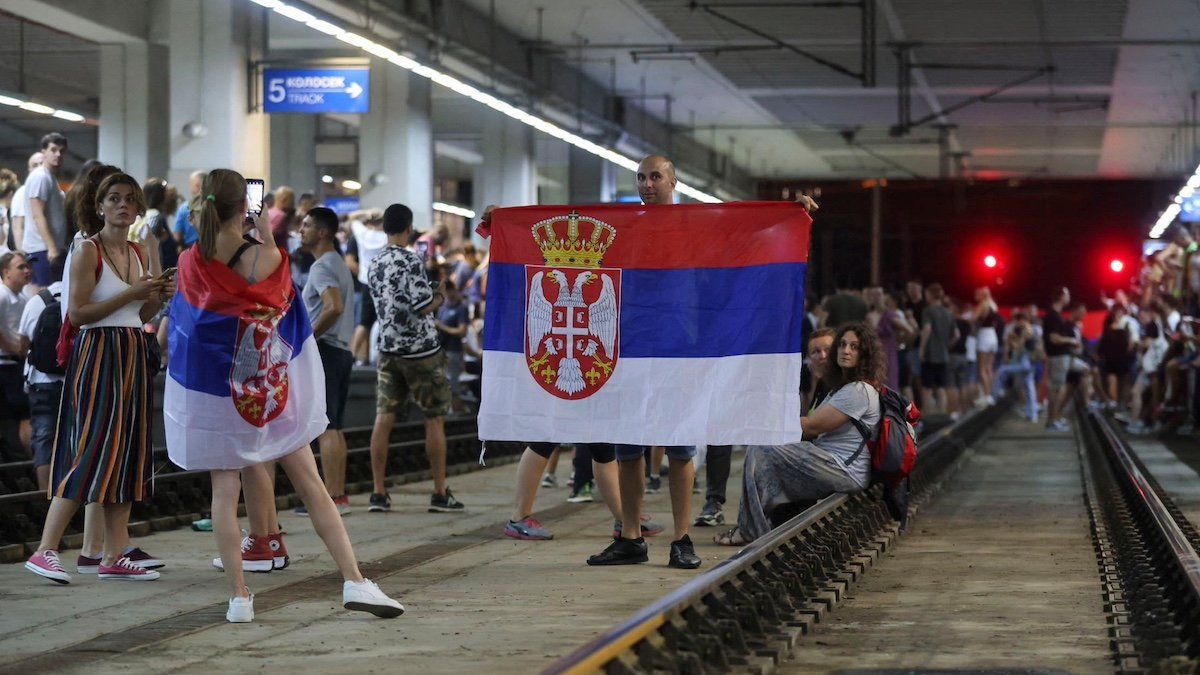 ​A demonstrator holds a flag as people block the Centre Railway Station during a protest against Rio Tinto's lithium mining project, in Belgrade, Serbia, August 10, 2024. 