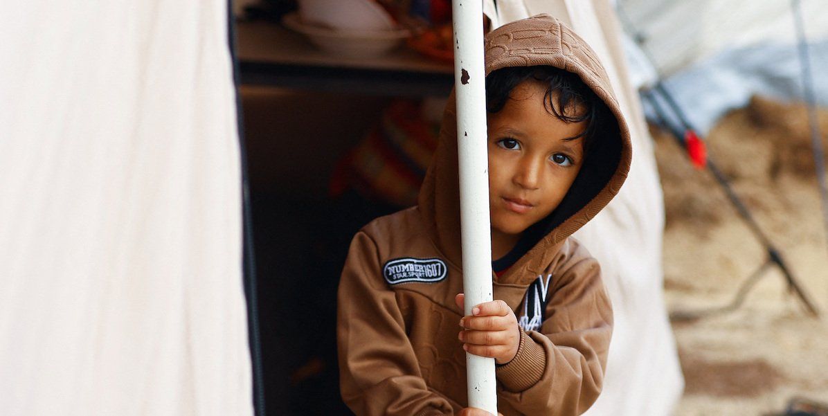 A displaced Palestinian child shelters in a tent camp, as the conflict between Israel and Hamas continues, in Khan Younis in the southern Gaza Strip, November 15, 2023.