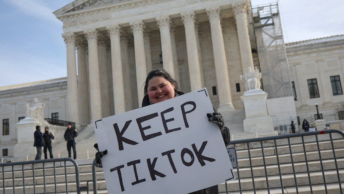 ​A person holds a placard on the day justices hear oral arguments in a bid by TikTok and its China-based parent company, ByteDance, to block a law intended to force the sale of the short-video app by Jan. 19 or face a ban on national security grounds, outside the U.S. Supreme Court, in Washington, U.S., January 10, 2025. 