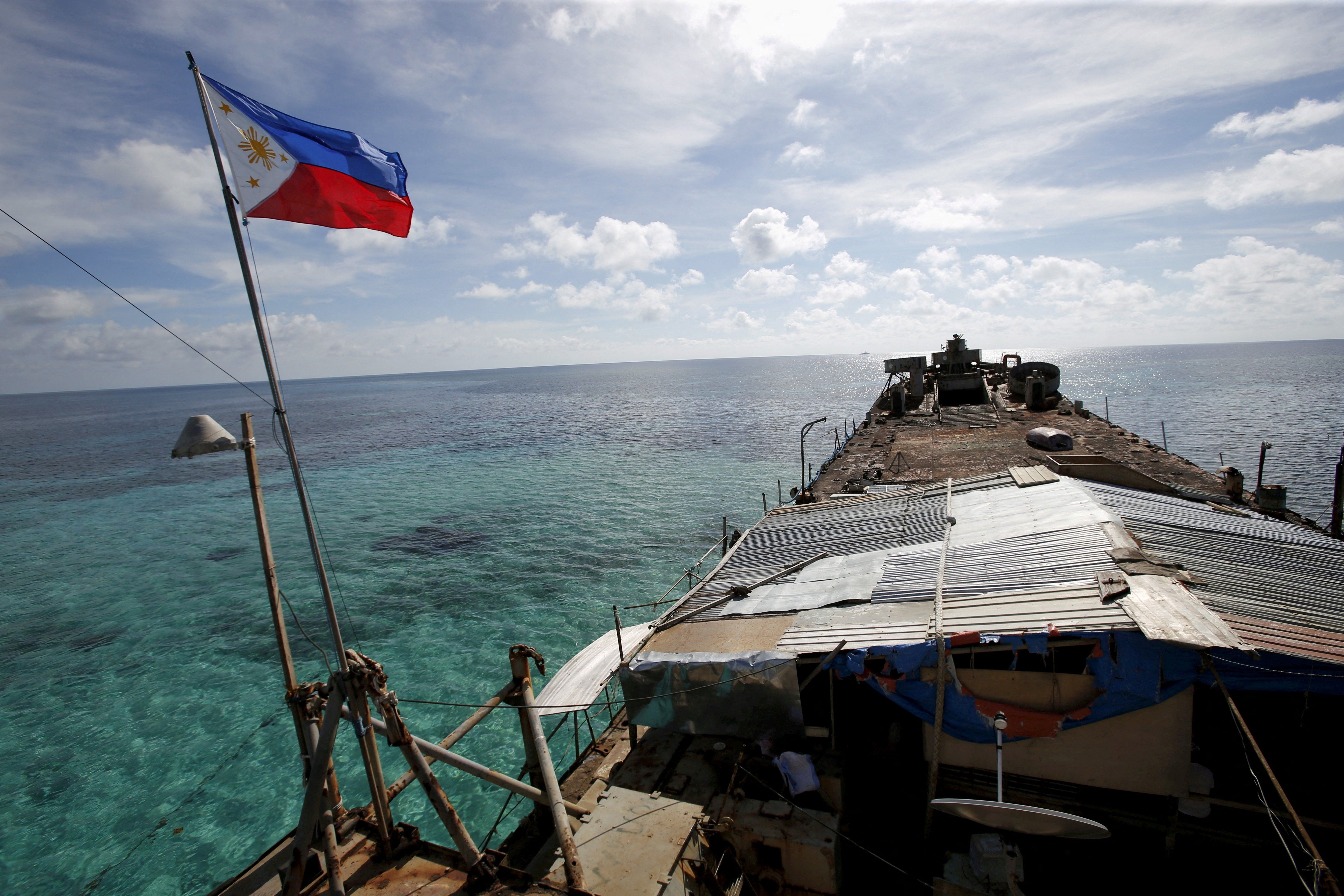 ​A Philippine flag flutters from BRP Sierra Madre, a dilapidated Philippine Navy ship that has been aground since 1999 and became a Philippine military detachment on the disputed Second Thomas Shoal, part of the Spratly Islands, in the South China Sea March 29, 2014. 