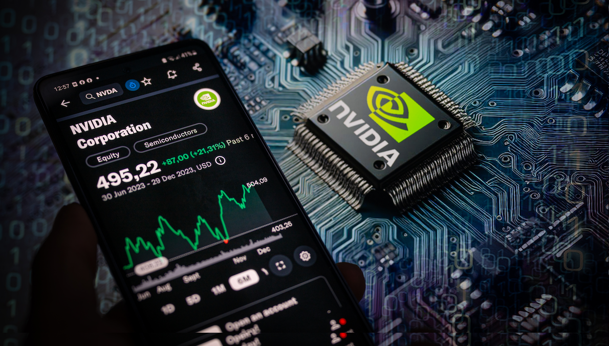 ​A photo illustration of a smartphone displaying the NVIDIA Corporation stock price on the NASDAQ market, with an NVIDIA chip visible in the background. 