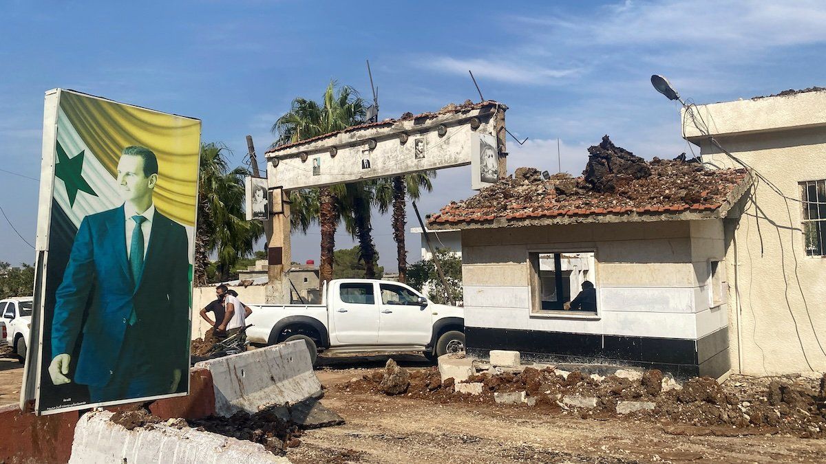 A poster depicting Syria's President Bashar al-Assad is seen at a damaged area in the aftermath of what Syrian state media reported was an Israeli strike in Hama, Syria September 9, 2024. 