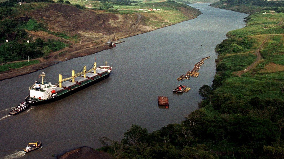 A ship passes through the Panama Canal's Culebra Cut, heading northbound for the Caribbean, Dec 30. The Canal, built and operated by the United States, will transfer to Panamanian control at a noon ceremony on December 31.