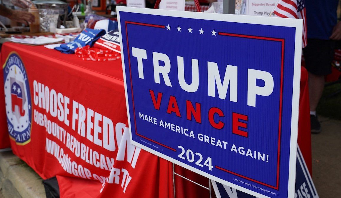 A Trump Vance campaign sign sits at the Cobb County Republican Party's booth at the Pigs and Peaches Country Festival in Kennesaw, Georgia, on Aug. 17, 2024. 