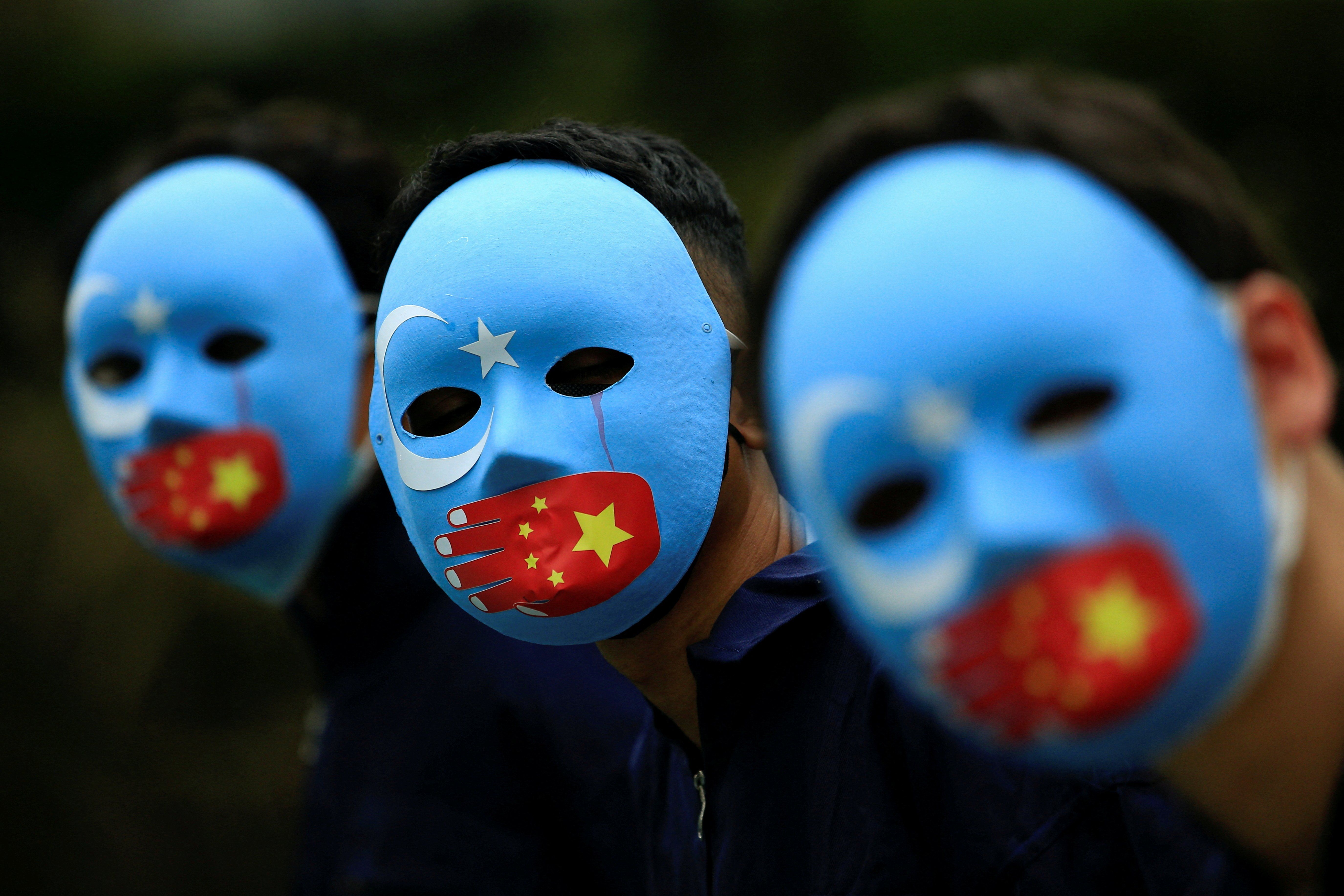 Activists take part in a protest against China's treatment of the ethnic Uyghur people in Jakarta, Indonesia.