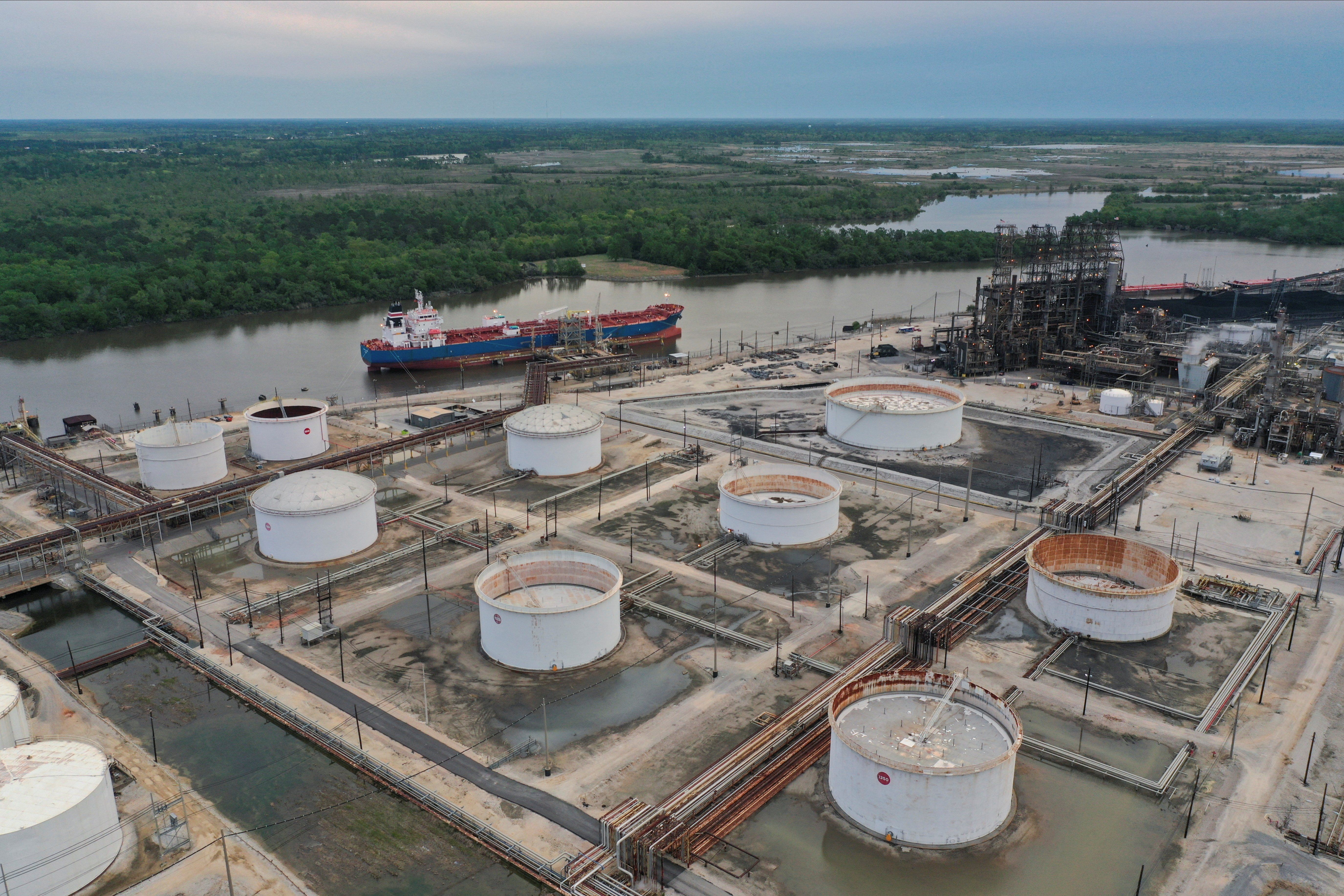 ​An aerial view of an oil tanker and storage tanks at Exxon Mobil’s Beaumont oil refinery, which produces and packages Mobil 1 synthetic motor oil, in Beaumont, Texas, U.S., March 18, 2023. 