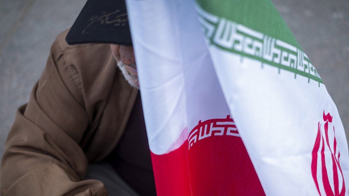 ​An elderly man holds an Iranian flag during an anti-U.S. and anti-Israel rally marking the anniversary of the U.S. embassy occupation outside the former U.S. embassy in downtown Tehran, Iran, on November 3, 2024, two days before the U.S. Presidential elections. 