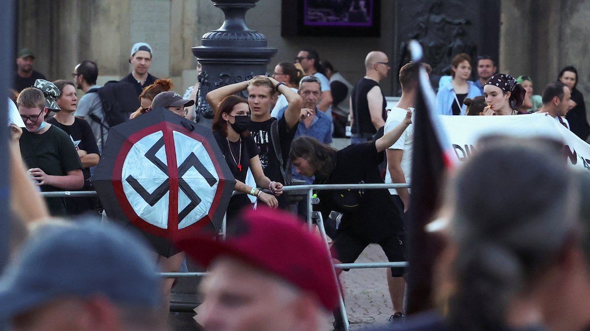 ​Attendees of Germany's Alternative for Germany (AfD) campaign event for the Saxony state elections leave, as counter protestors stand in the background, in Dresden, Germany, August 29, 2024. 