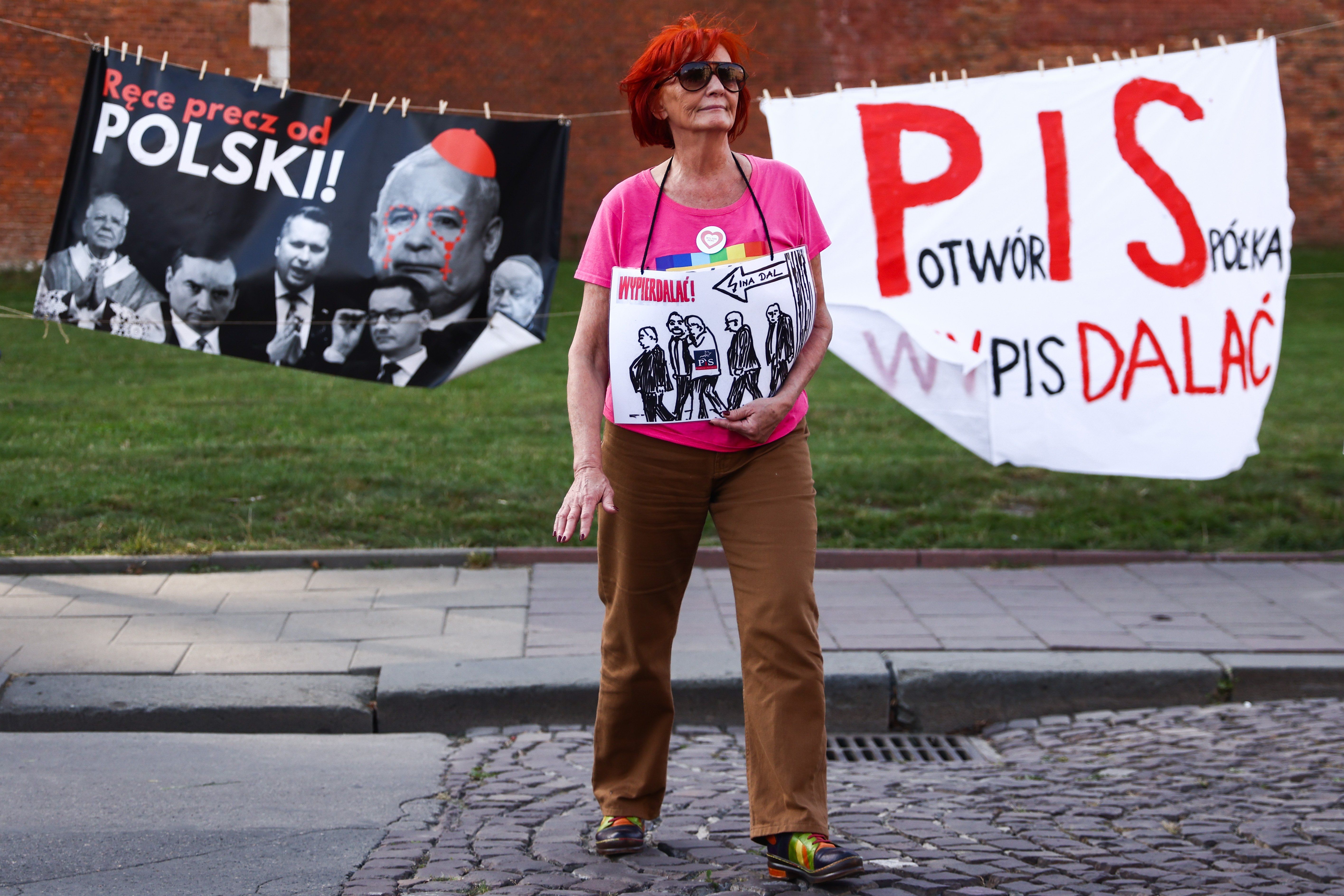 Banners ares seen during an anti-government protest in Krakow, Poland