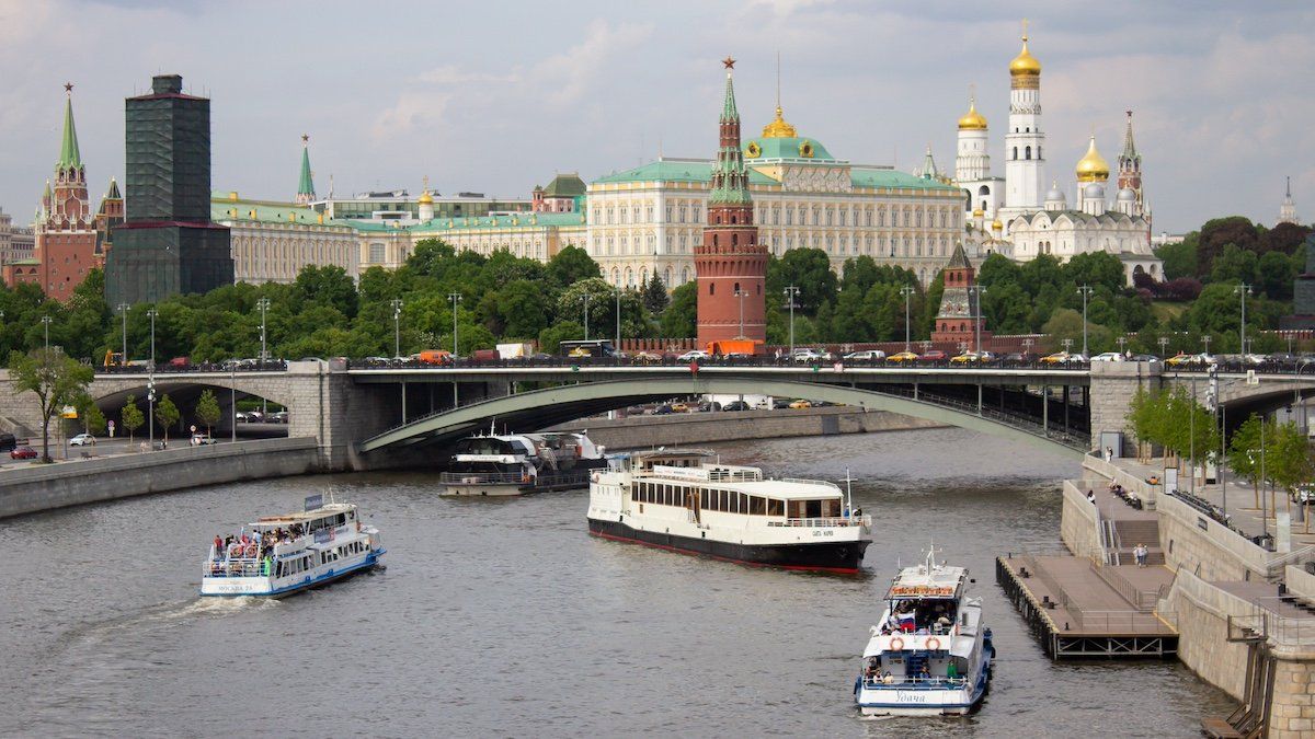 Boats navigate the Moscow River near the Kremlin.