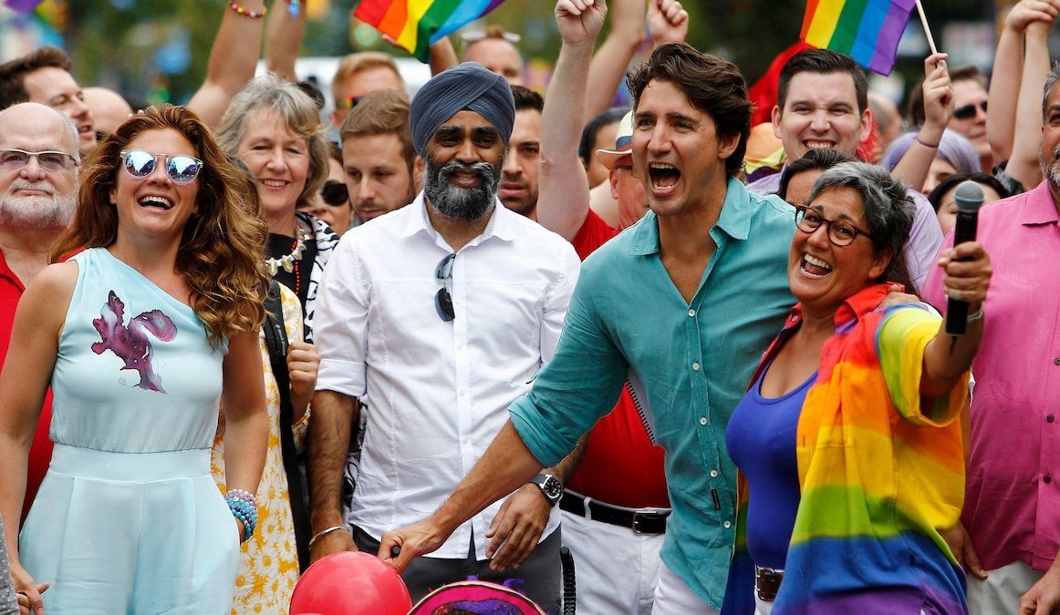 ​Canada's Prime Minister Justin Trudeau reacts as he and his wife Sophie Grégoire Trudeau (the two are now separated) walk in the Vancouver Pride Parade in Vancouver, British Columbia, on July 31, 2016. 