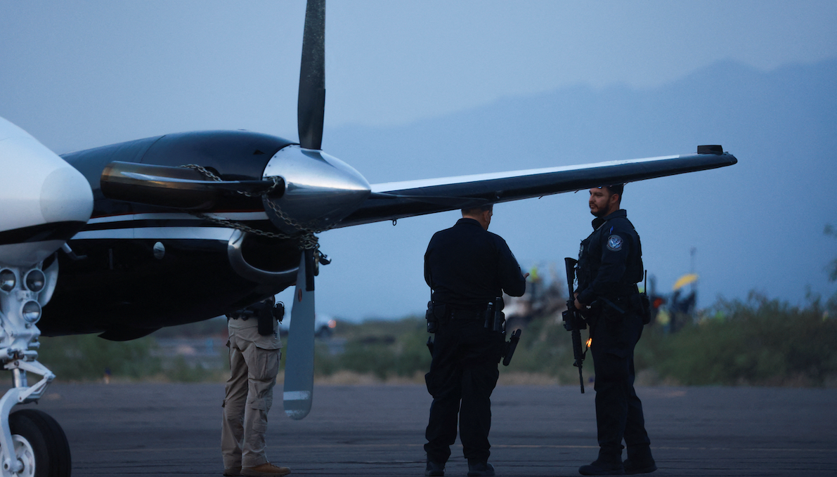 ​CBP agents stand by a plane that's believed to have carried Mexican drug lord Ismael "El Mayo" Zambada and Joaquin Guzman Lopez, who were arrested in El Paso, Texas. 