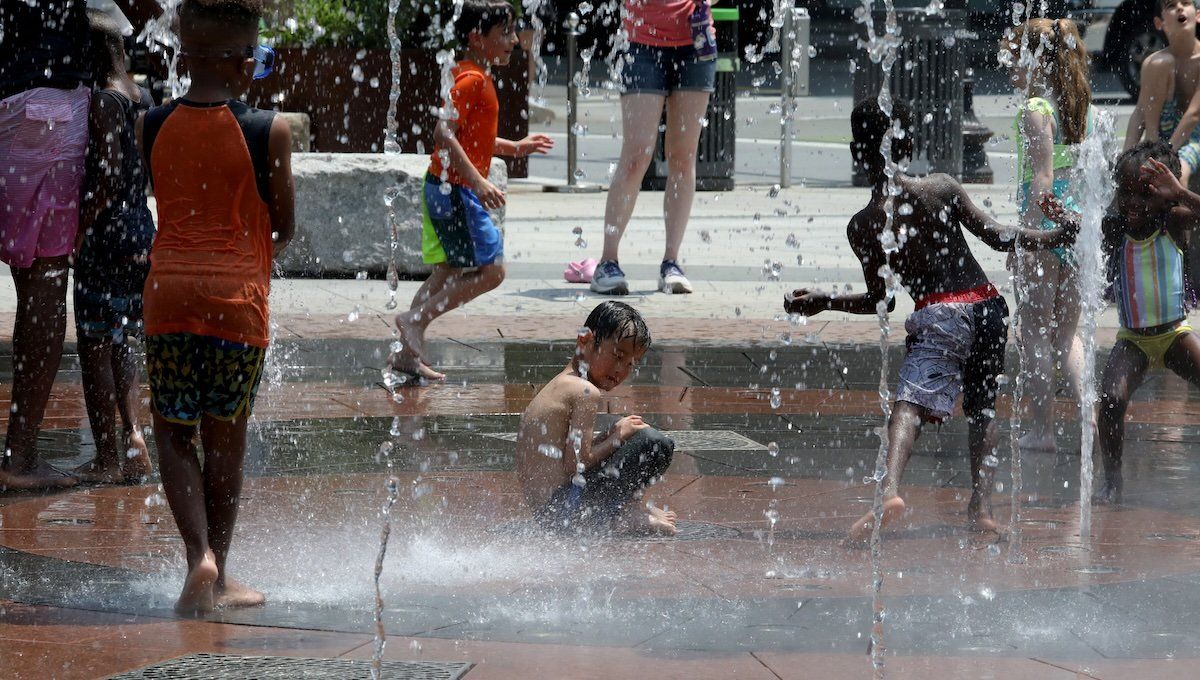 Children play in a city water feature during a heat wave affecting the U.S. Northeast in Boston, Massachusetts, U.S. June 19, 2024.