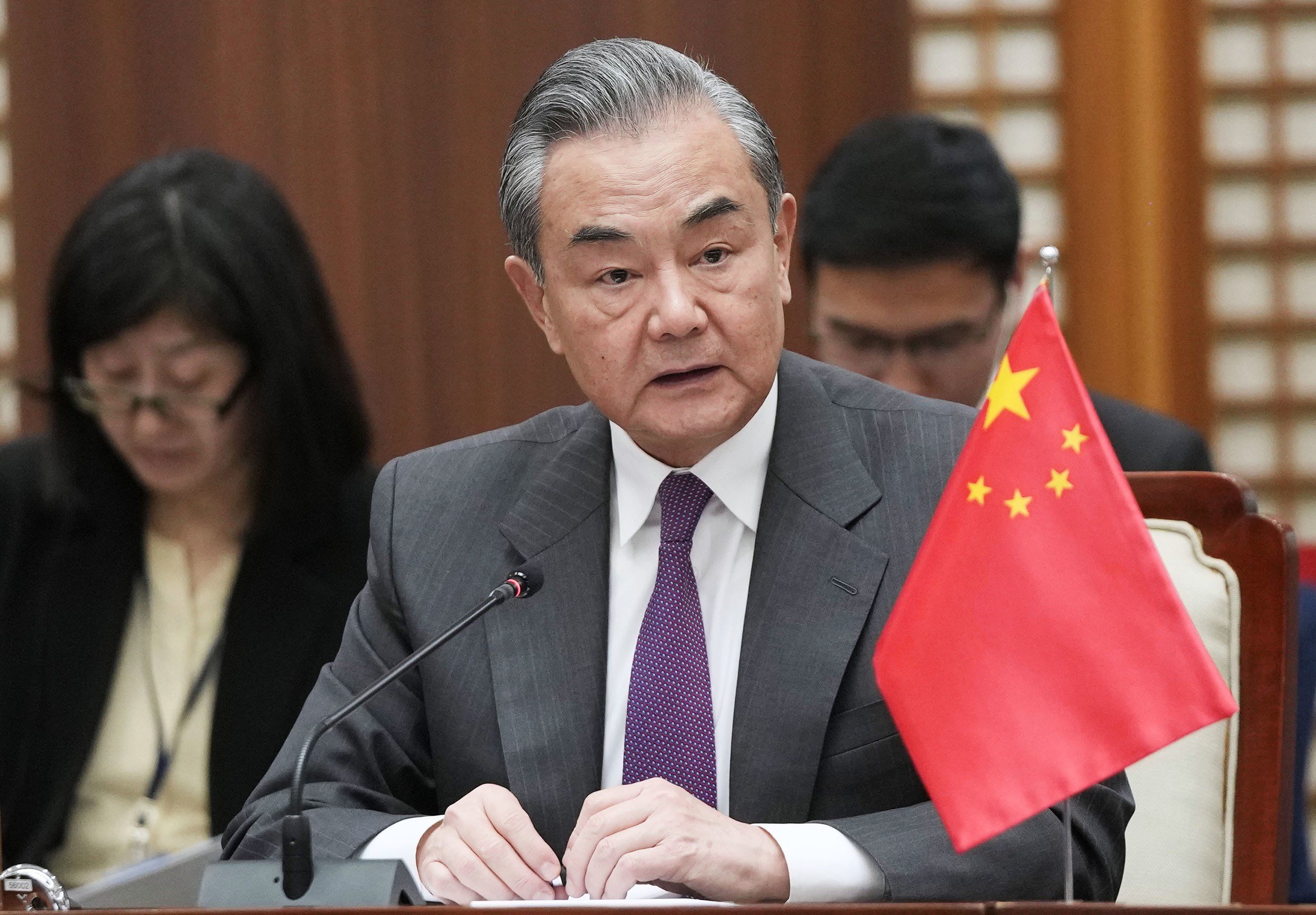 China's top diplomat Wang Yi speaks at a meeting with his Japanese and South Korean counterparts, Yoko Kamikawa and Park Jin, in Busan, South Korea, on Nov. 26, 2023.