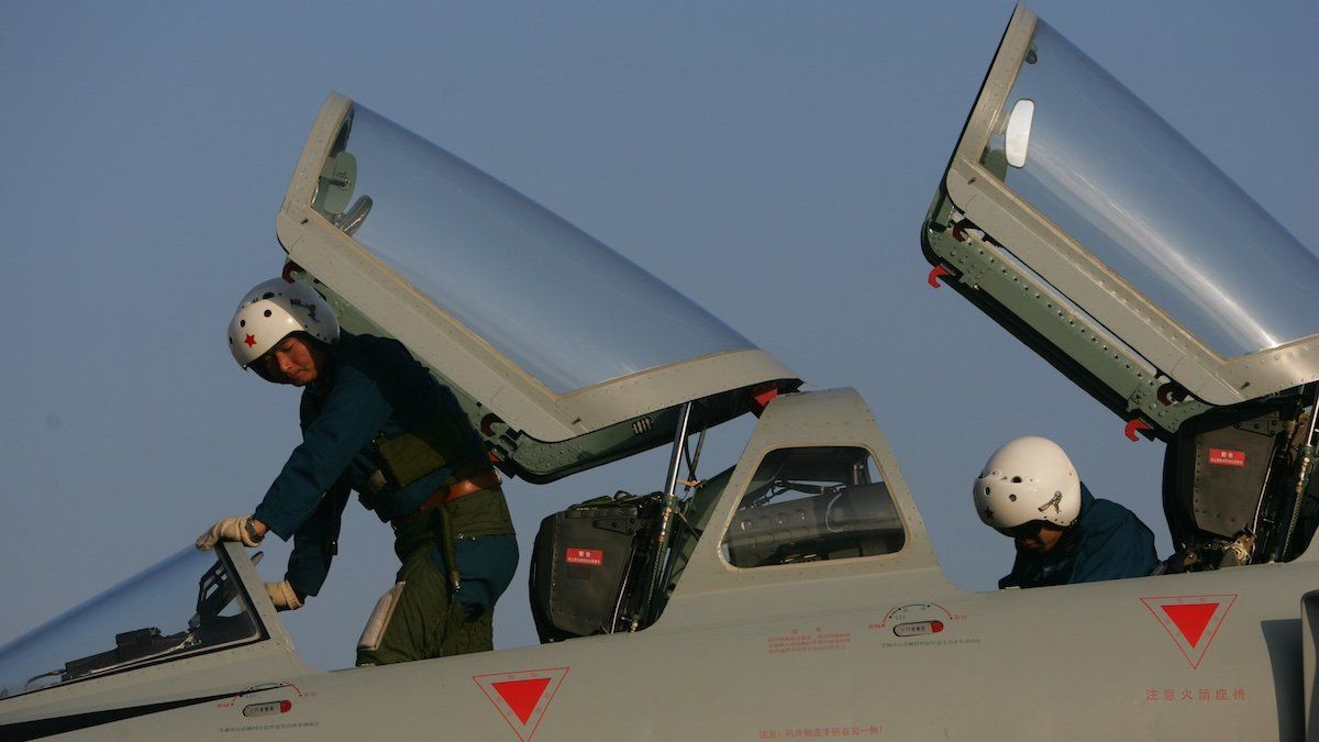 Chinese pilots deplane from a JH-7 fighter-bomber in preparation for the 9th China International Aviation and Aerospace Exhibition, known as Airshow China 2012, in Zhuhai city, south Chinas Guangdong province, 10 November 2012.