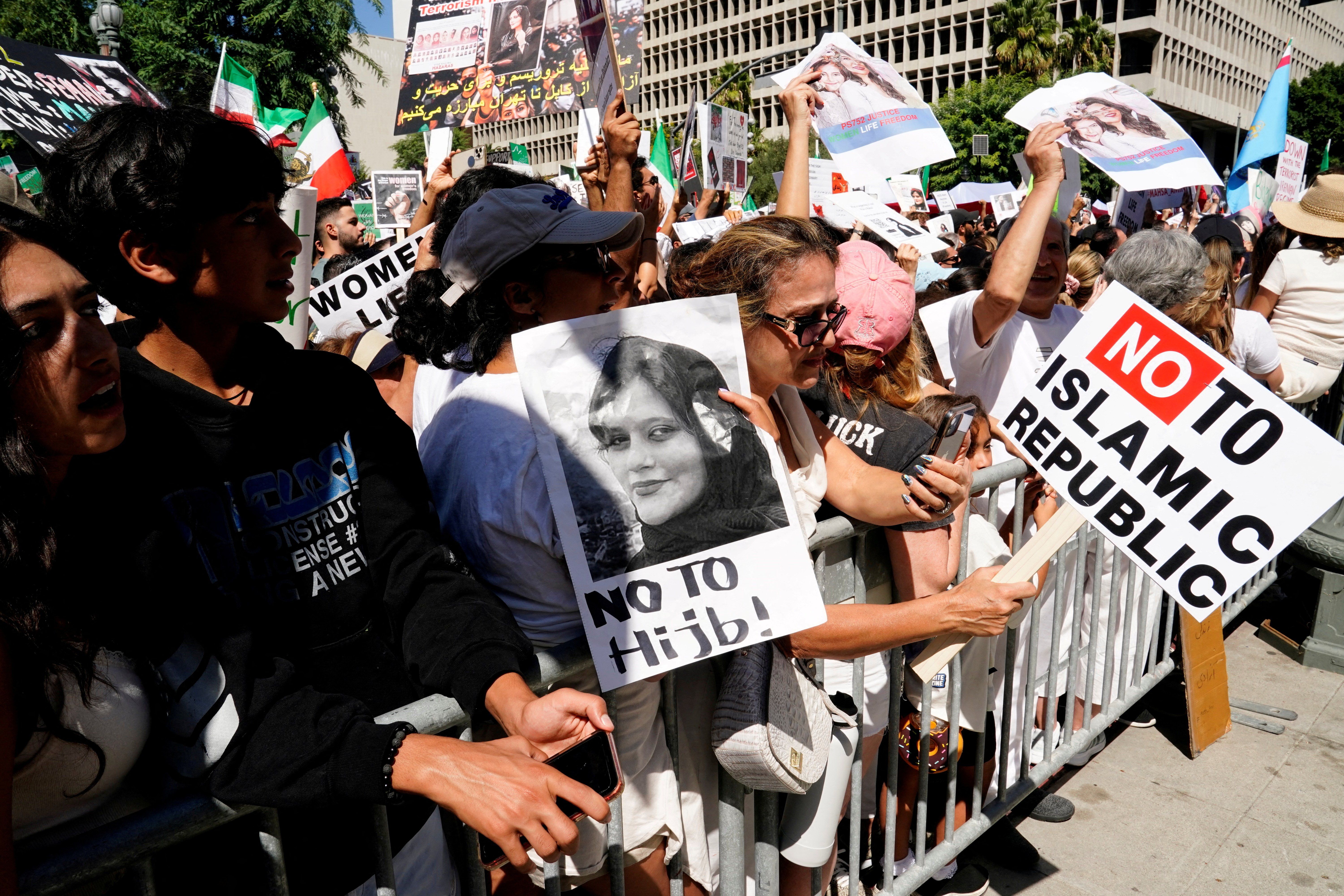 Demonstrators display images of Mahsa Amini, who died in policy custody in Tehran in Sept. 2022. 