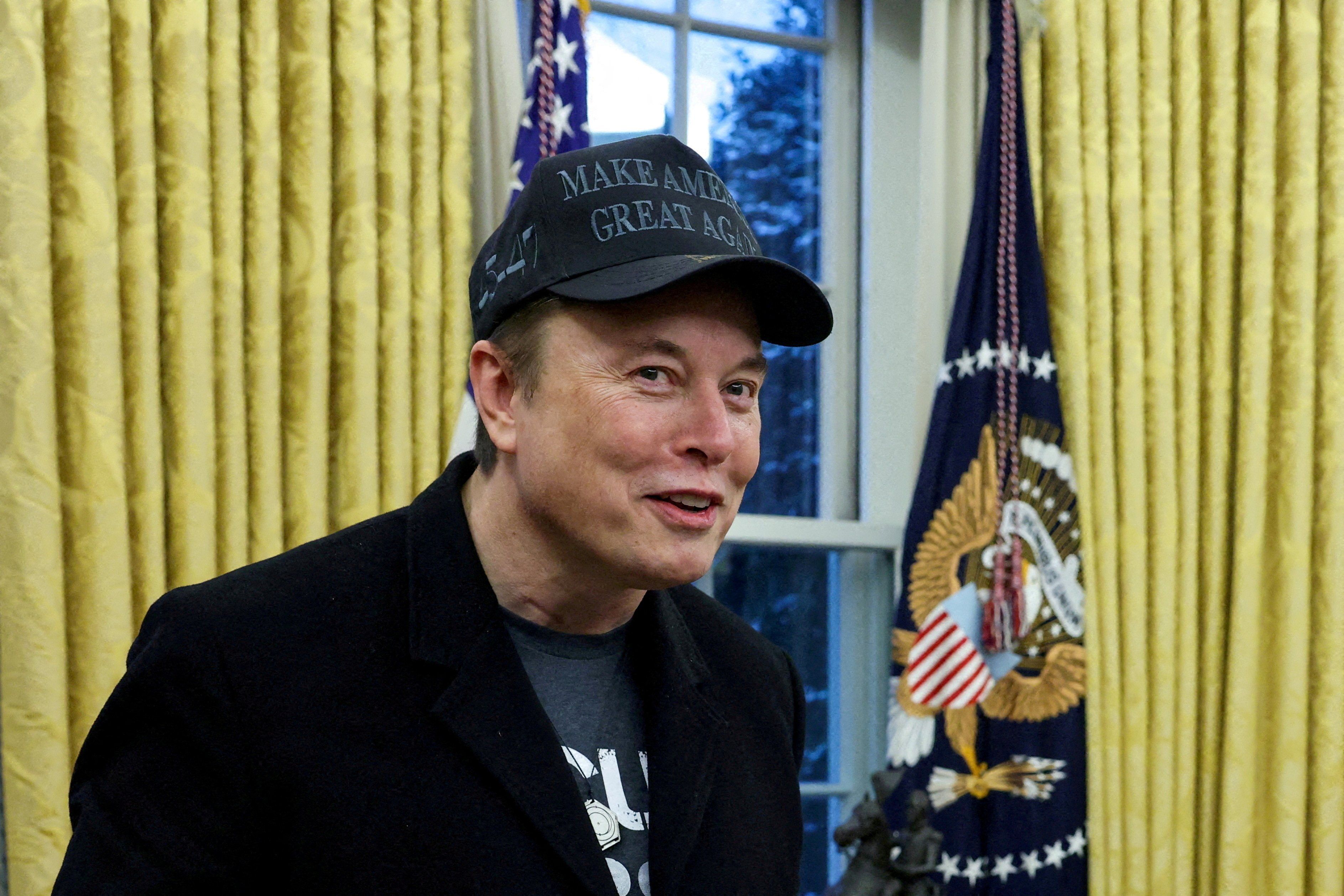 Elon Musk speaks next to U.S. President Donald Trump (not pictured) in the Oval Office of the White House in Washington, D.C., U.S., February 11, 2025. 