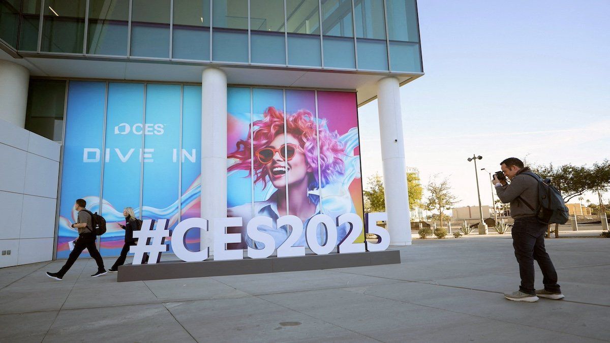 ​FILE PHOTO: A man takes a photo of a CES sign as setup continues for CES 2025, an annual consumer electronics trade show, in Las Vegas, Nevada, U.S. January 5, 2025. 