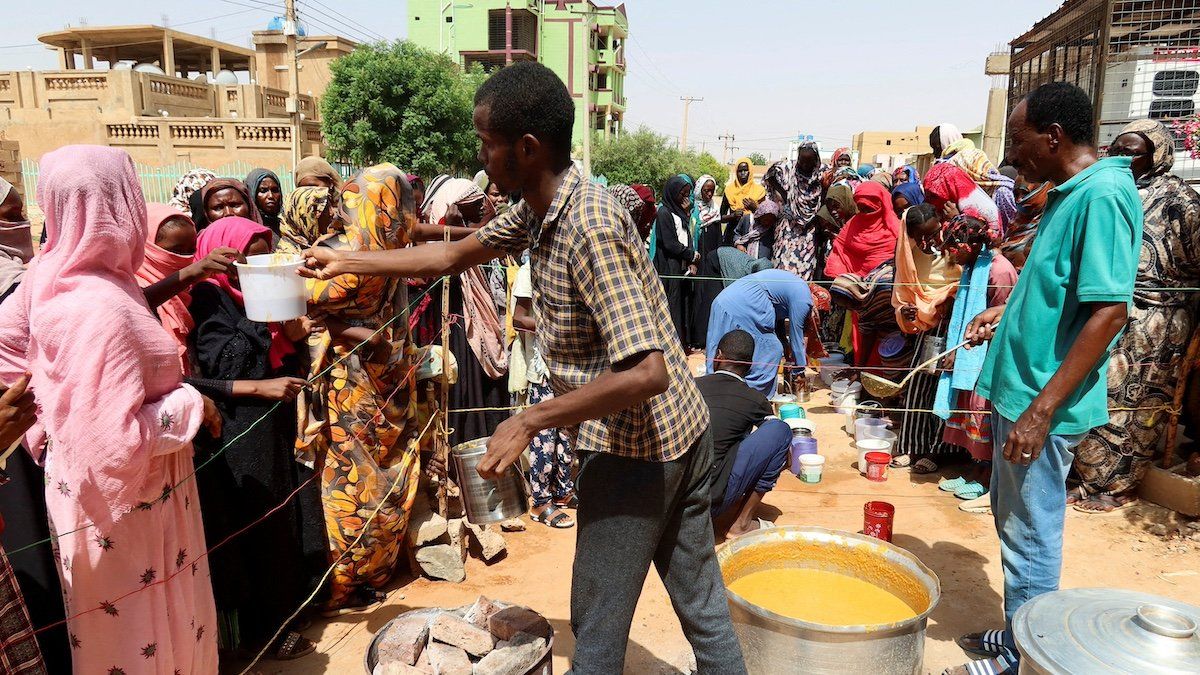 ​FILE PHOTO: A volunteer distributes food to people in Omdurman, Sudan, September 3, 2023. 