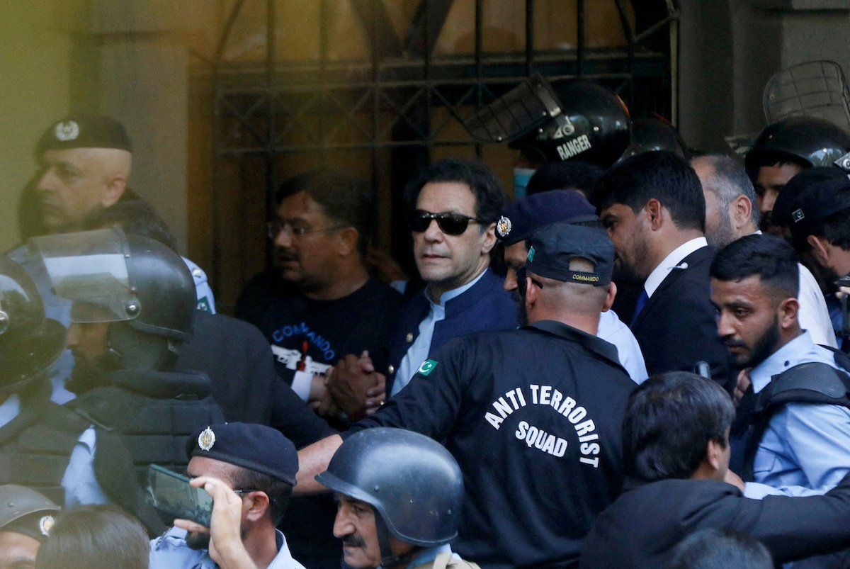 FILE PHOTO: Security officers escort Pakistan's former Prime Minister Imran Khan, as he appeared in Islamabad High Court, Islamabad, Pakistan May 12, 2023.