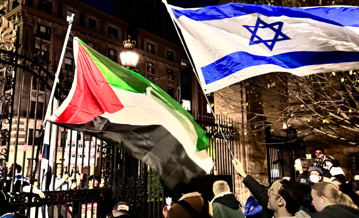 Flags from across the divide wave in the air over protests at Columbia University on Thursday, April 25, 2024.