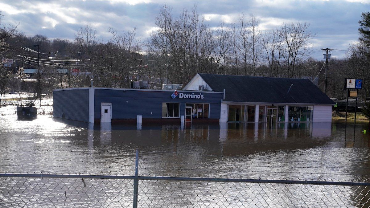 ​Floodwaters cover a parking lot on the Yantic River after heavy rains in Norwichtown, Connecticut, U.S., January 10, 2024. 