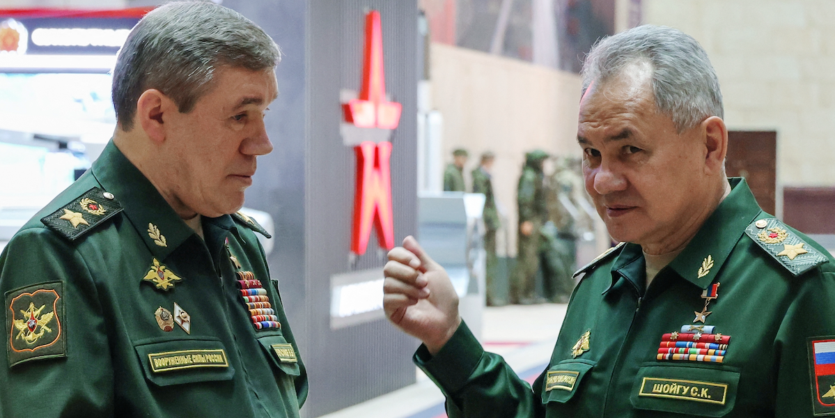 ​Former Russian Defence Minister Sergei Shoigu and Chief of the General Staff of Russian Armed Forces Valery Gerasimov talk in December 2023. Both men now face ICC warrants for alleged war crimes.