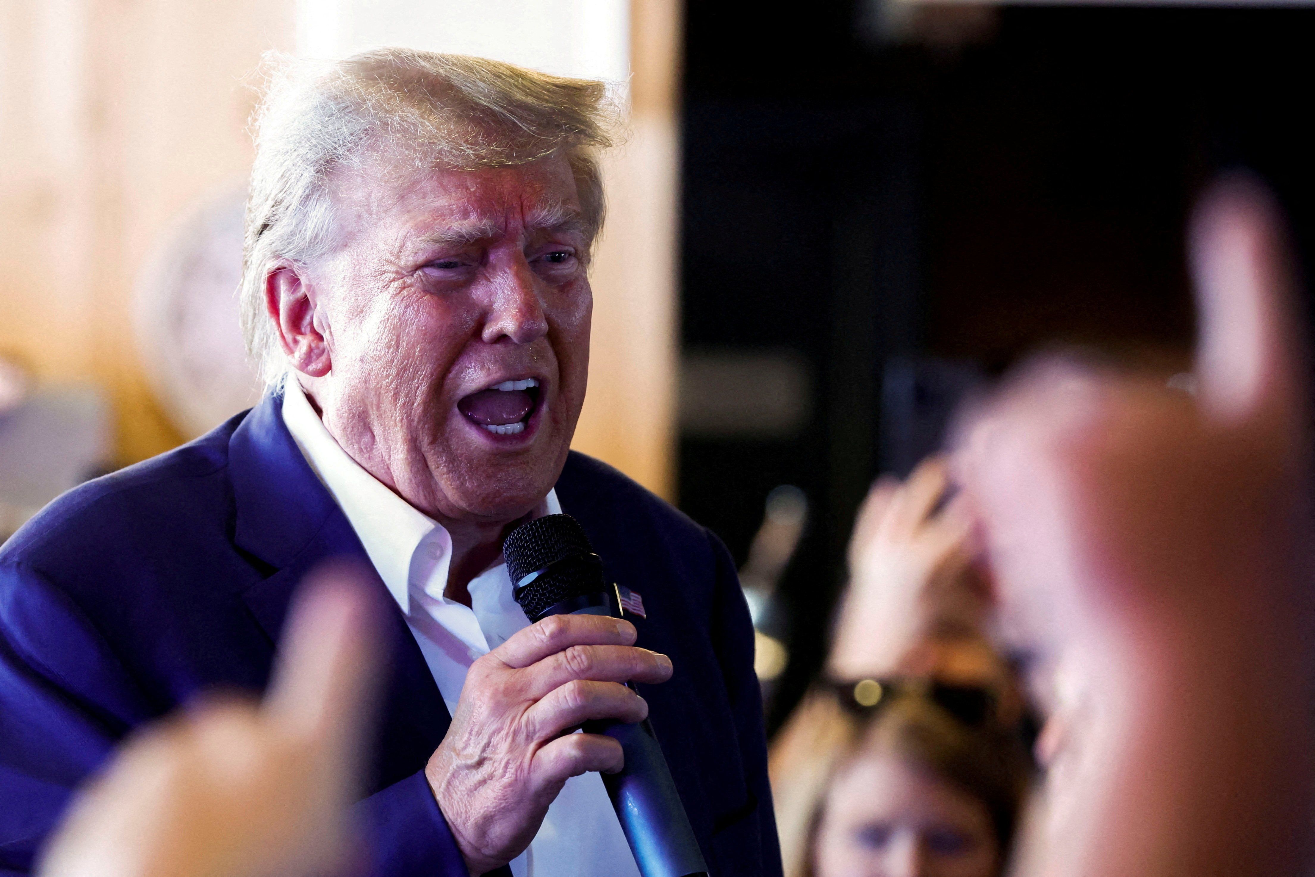 Former U.S. President Donald Trump speaks as he campaigns in Iowa. 