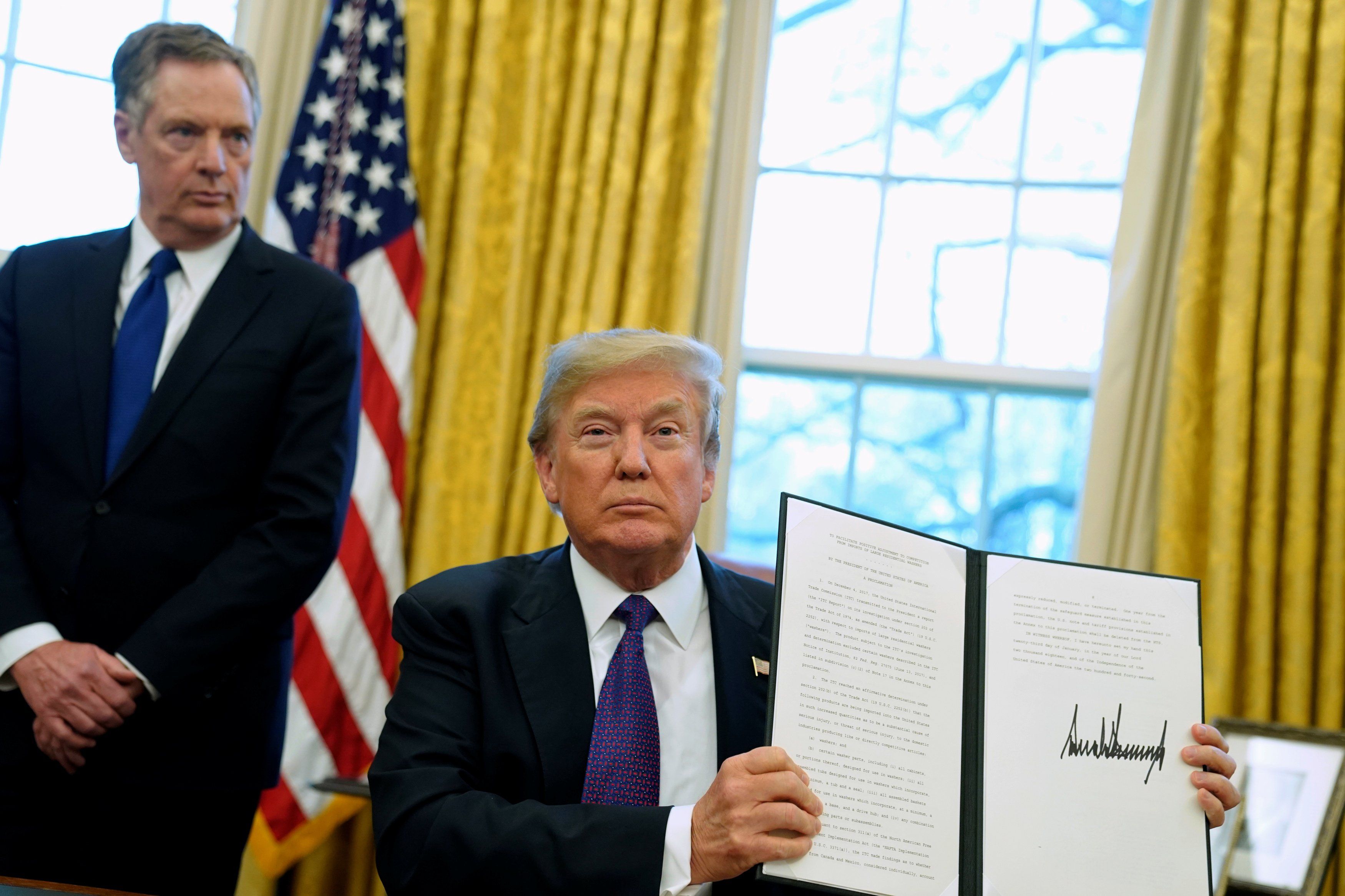 Former US President Donald Trump, flanked by Trade Representative Robert Lighthizer, at the White House. 