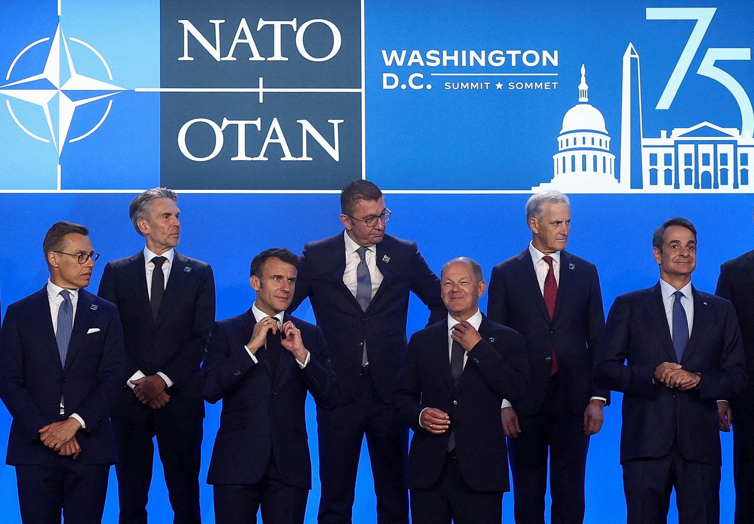 ​French President Emmanuel Macron, German Chancellor Olaf Scholz and Greek Prime Minister Kiriakos Mitsotakis stand together during NATO's 75th anniversary summit in Washington, U.S., July 10, 2024. 