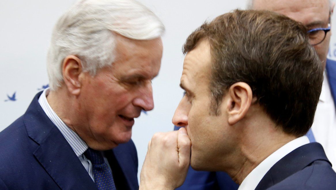 ​French President Emmanuel Macron speaks with then-EU Chief Brexit Negotiator Michel Barnier in February 2019.