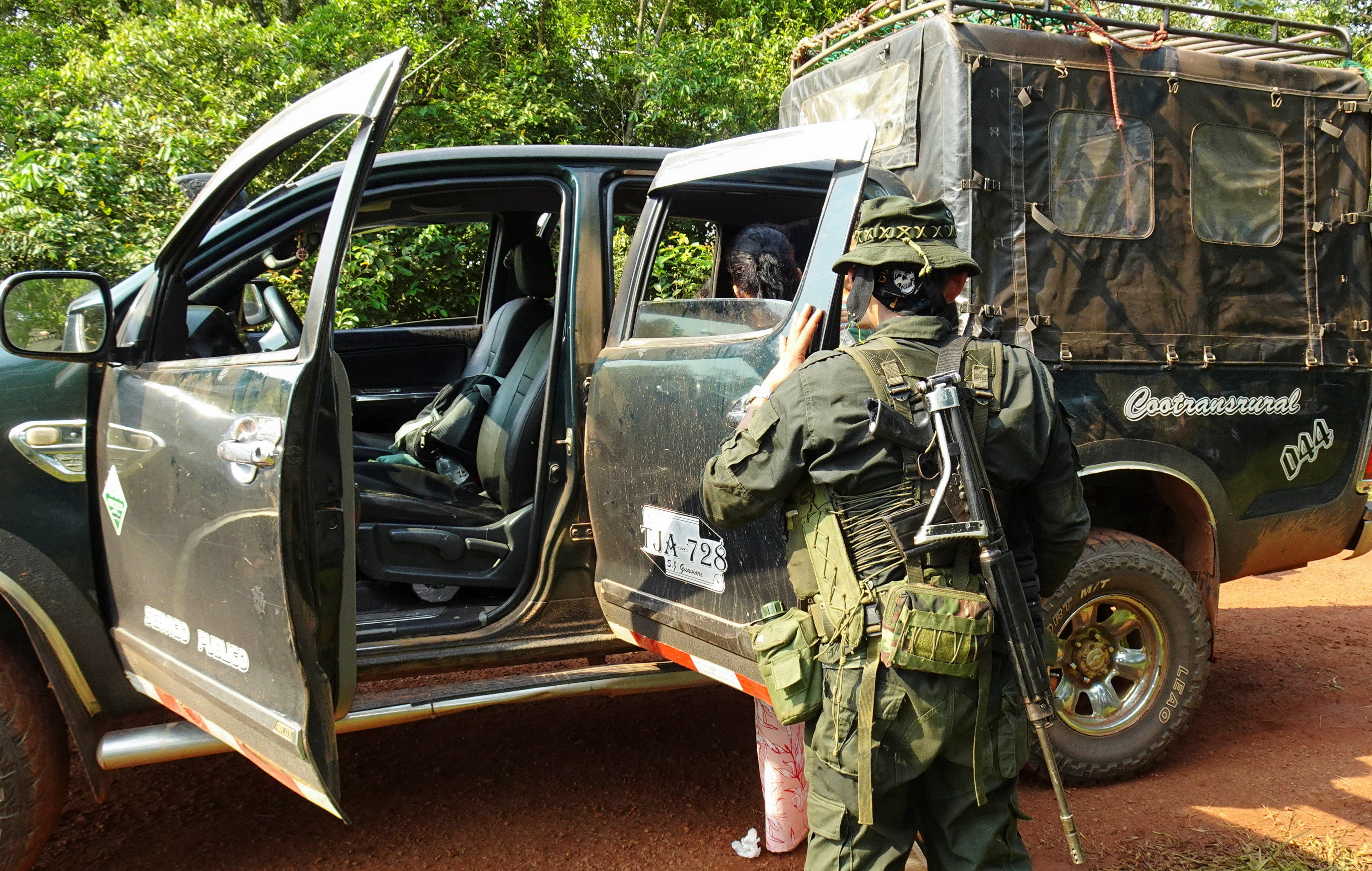 Guerrillas of the Central General Staff (EMC), a faction of the FARC that rejected the 2016 peace agreement and continued the armed struggle, inspect vehicles at a checkpoint installed on a highway in the Llanos del Yari, Colombia April 12, 2024. 