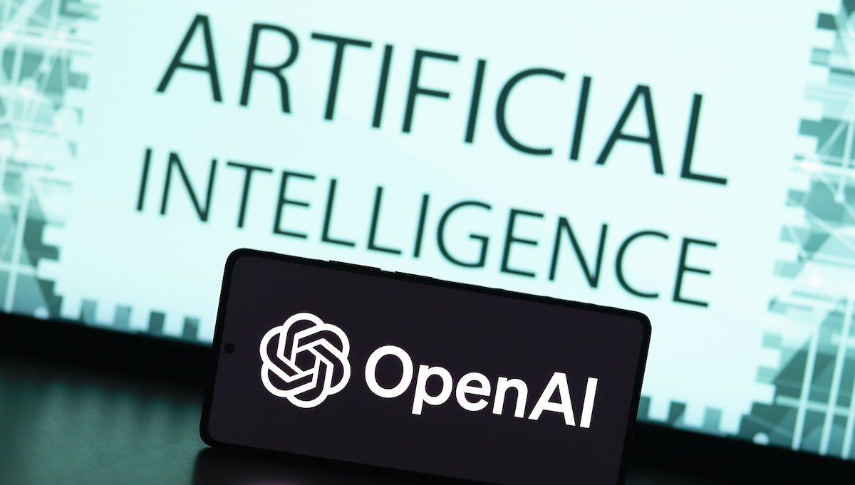 In this photo illustration, the OpenAI logo is displayed on a smartphone screen with the text artificial intelligence in the background.