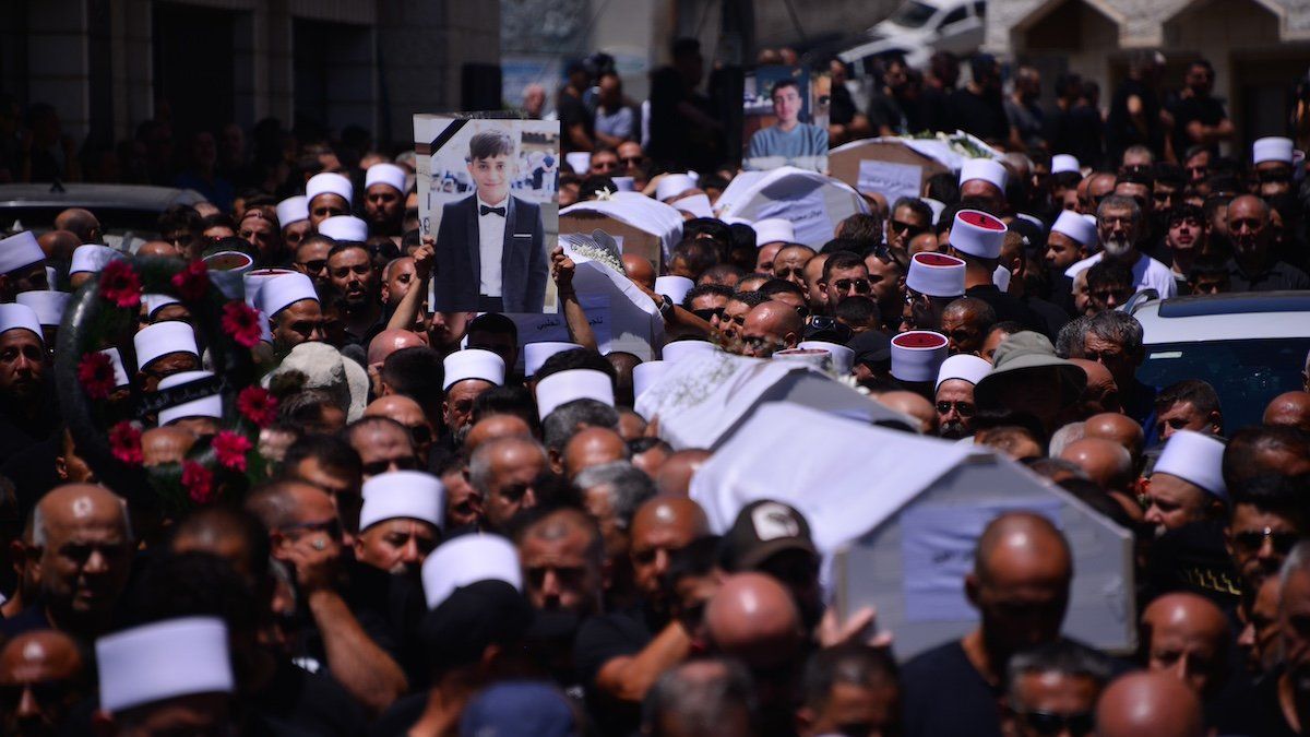 Israeli Druze mourners gathered for the funeral of the 12 children and teens killed in a Hezbollah rocket strike a day earlier at a soccer field at the village of Majdal Shams in the Golan Heights. Majdal Shams, Israel. July 28th 2024.