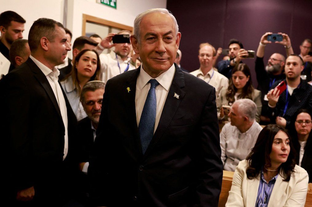 ​Israeli Prime Minister Benjamin Netanyahu smiles as he prepares to testify in his trial on corruption charges at the district court in Tel Aviv on Dec. 10, 2024. 