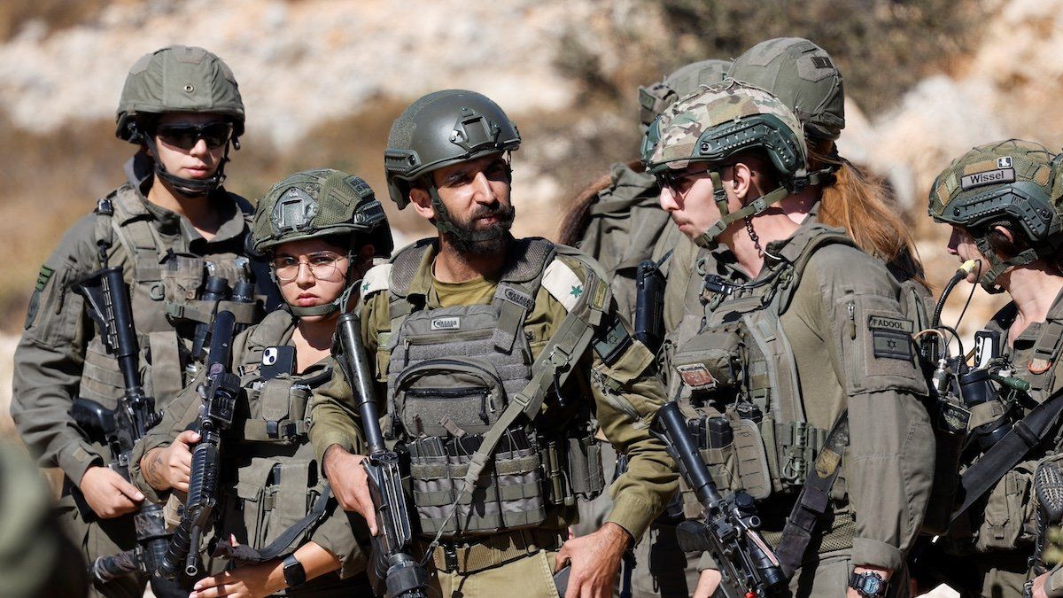 ​Israeli soldiers stand guard as they deny access to Palestinian farmers to harvest olives, in Burqa near Ramallah in the Israeli-occupied West Bank October 20, 2024. 