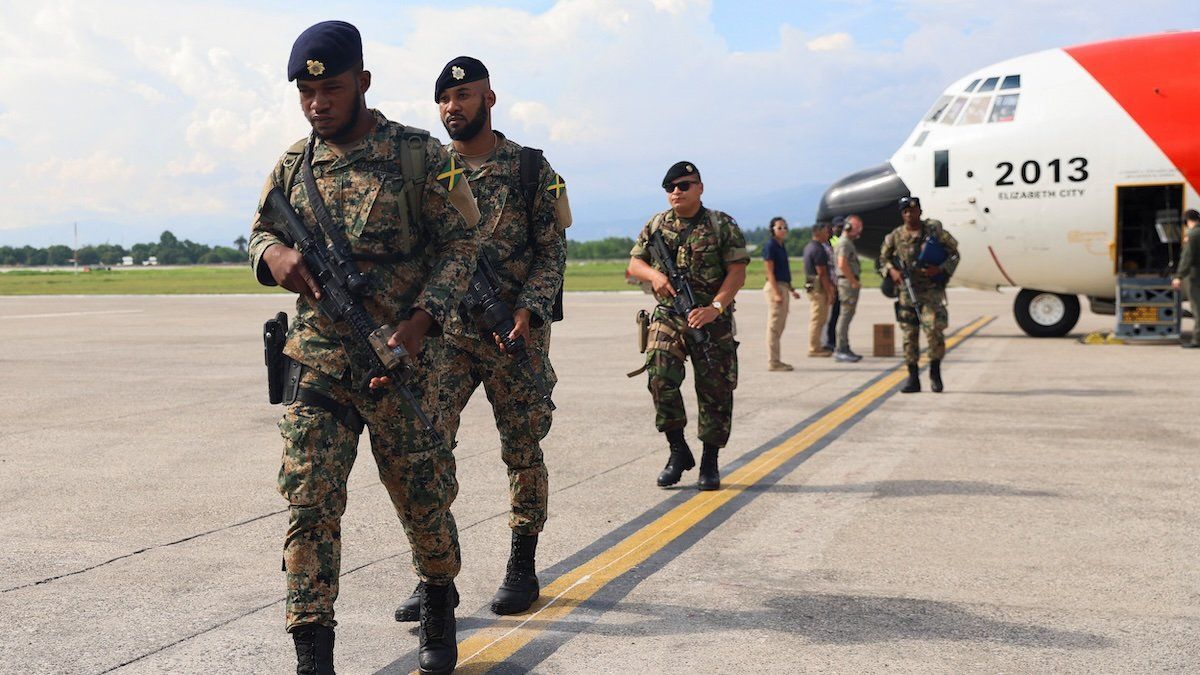 Jamaican and Belizean security personnel disembark from a U.S. Coast Guard airplane in a deployment to support an international security mission aimed at fighting gangs, at Toussaint Louverture International Airport in Port-au-Prince, Haiti September 12, 2024.