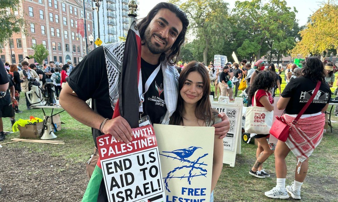 ​Jousef Shkoukani and his wife, Yara Rashad, join other protesters in Chicago's Union Park on Monday, Aug. 19.