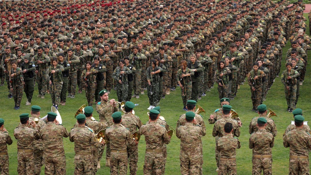 Kurdish fighters from the People's Protection Units (YPG) take part in a military parade as they celebrate victory over the Islamic state, in Qamishli, Syria March 28, 2019. 