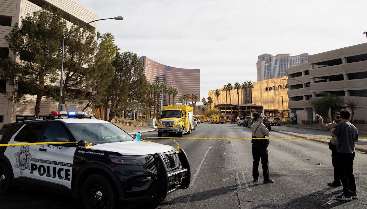 ​Law enforcement officers stand behind yellow tape in a cordoned area, after a Tesla Cybertruck burned at the entrance of Trump Tower, in Las Vegas, Nevada, on Jan. 1, 2025. 