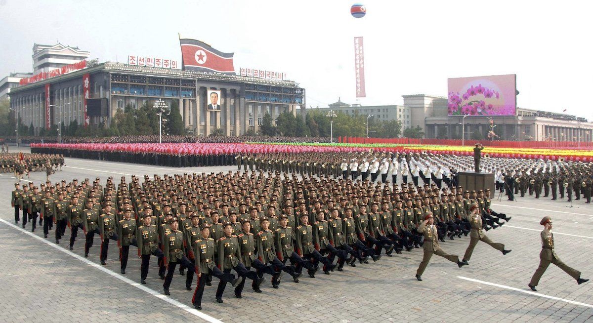 North Koreans take part in a parade to commemorate the 65th anniversary of the founding of the Workers' Party of Korea in Pyongyang October 10, 2010. 