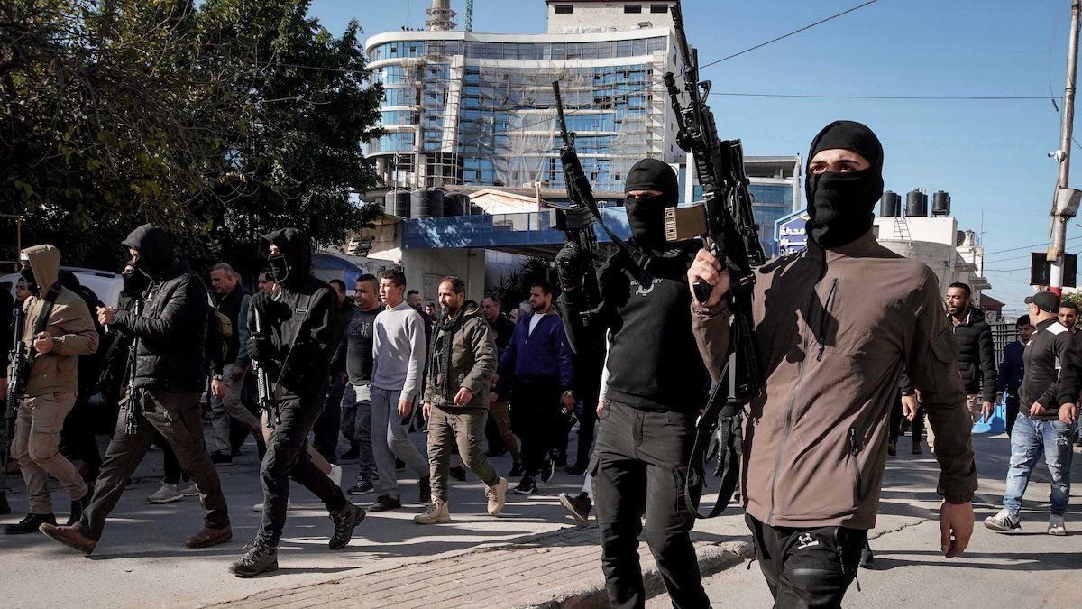 ​Palestinian gunmen attend the funeral of the Palestinians who were killed in an Israeli army raid in the West Bank city of Jenin, Jan. 7, 2024.