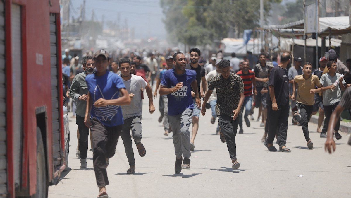 Palestinians flee the area after an Israeli attack on July 13, 2024 in Khan Younis, Gaza Strip.