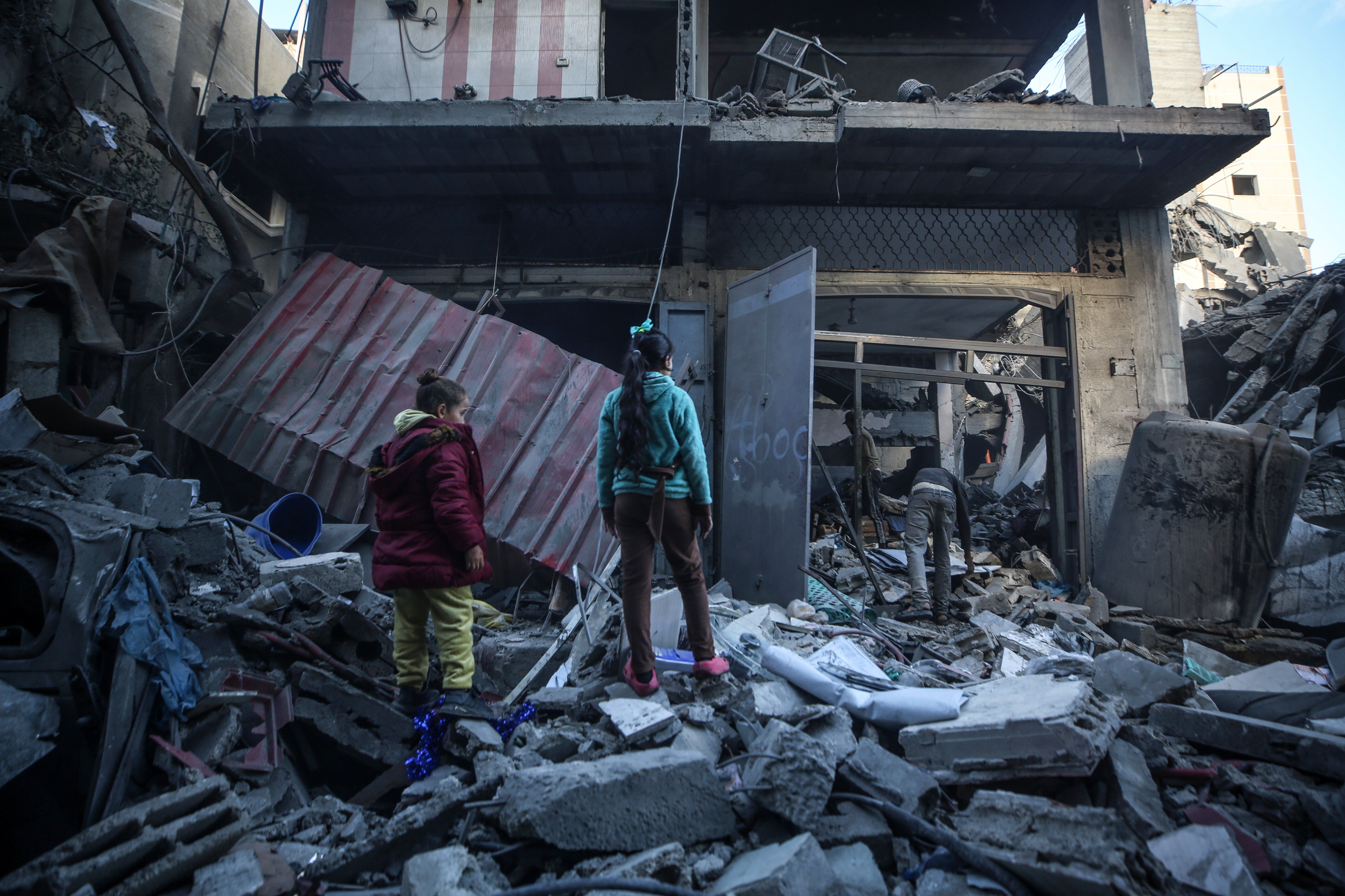 ​Palestinians inspect damage at the site of an Israeli strike on a house amid the Israel-Hamas conflict at the Nuseirat refugee camp in the central Gaza Strip on December 13, 2024. 