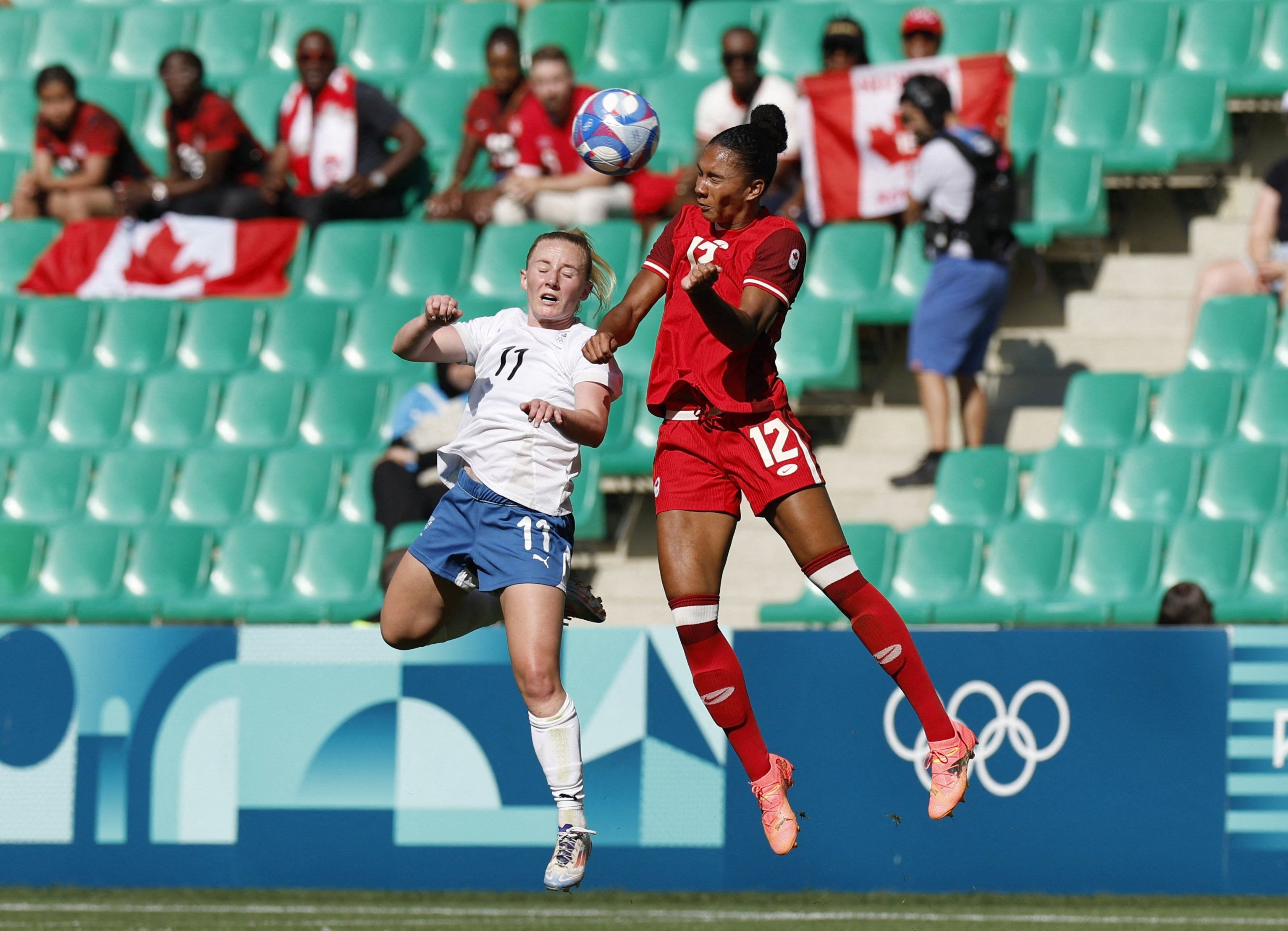 Paris 2024 Olympics - Football - Women's Group A - Canada vs New Zealand - Geoffroy-Guichard Stadium, Saint-Etienne, France - July 25, 2024. Katie Kitching of New Zealand in action with Jade Rose of Canada. 