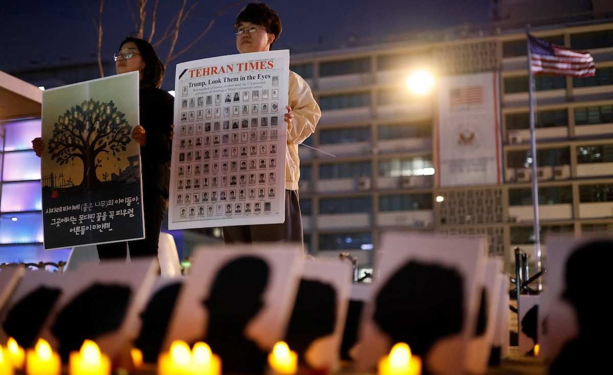 Participants hold placards during a protest to condemn the U.S. and Israeli attacks on Iran and commemorate students killed in a strike on a girls' primary school in Minab in southern Iran on February 28, in front of the U.S. embassy in Seoul, South Korea, March 12, 2026.