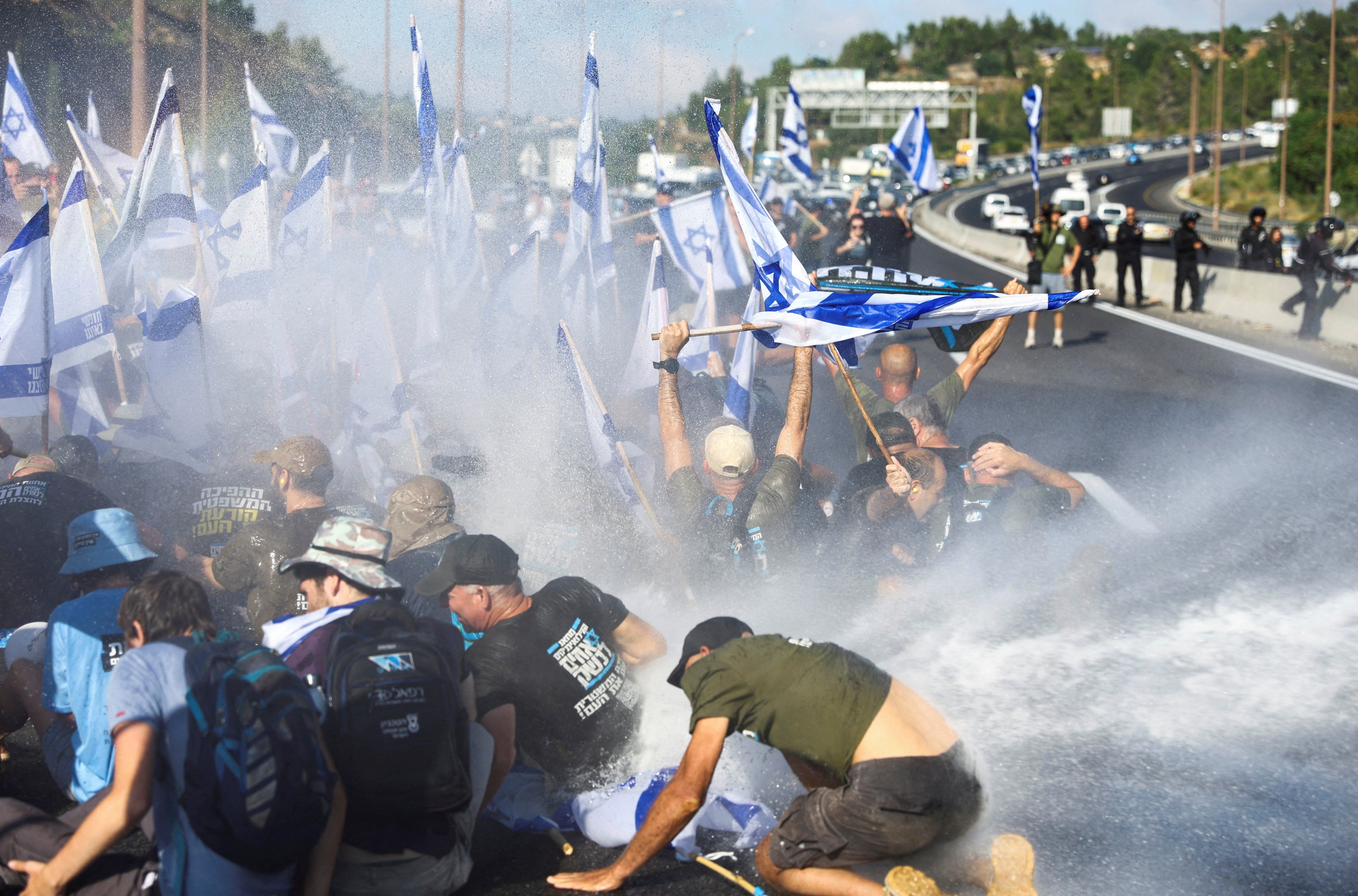 People block a highway to Jerusalem on a day of disturbance to protest against Israeli PM Benjamin Netanyahu and his nationalist coalition government's judicial overhaul.