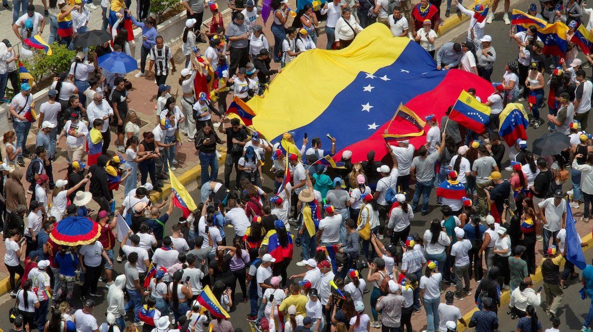 People carry Venezuela's national flag to protest the election results that awarded Venezuela's President Nicolas Maduro a third term, in Maracaibo, Venezuela, on July 30, 2024. 